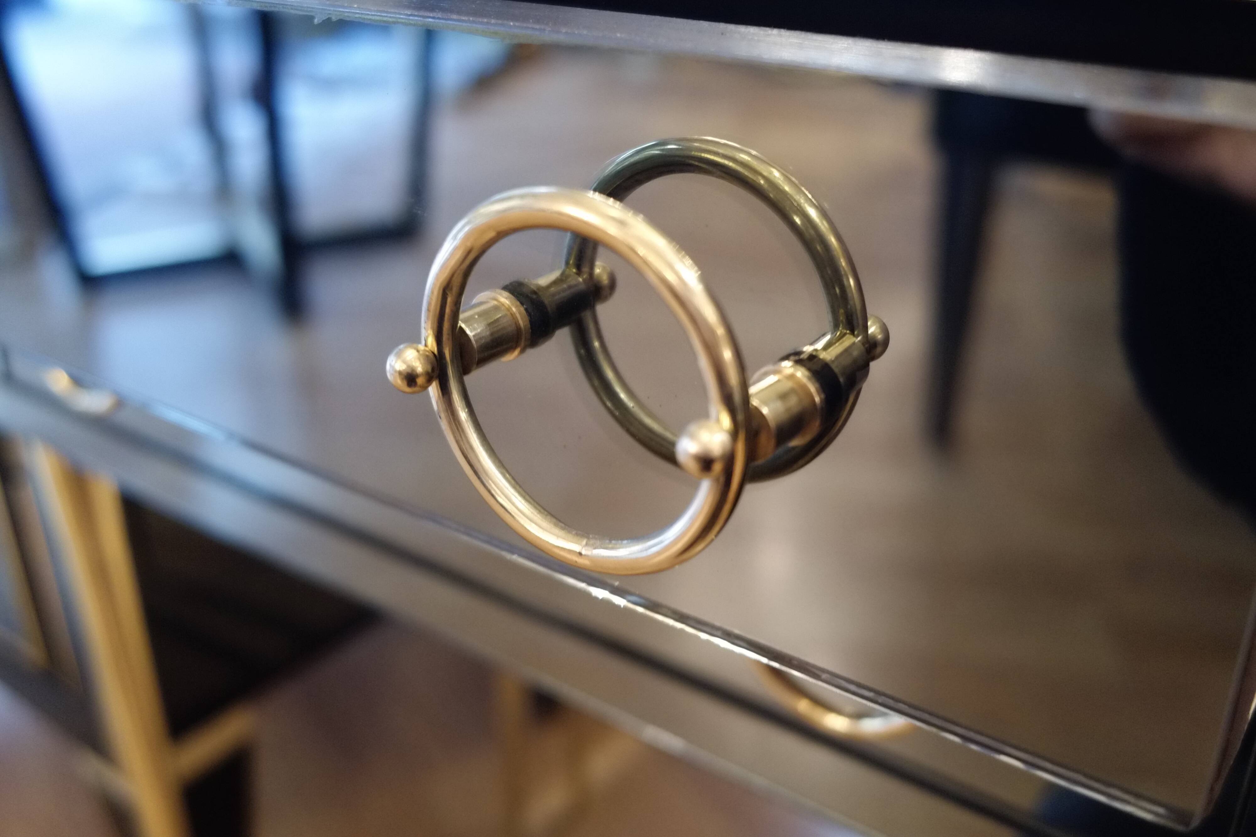 Pair of nightstands in anthracite colored glass and brass