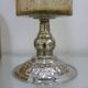 Amber crackled glass photophore on a metal candlestick base.