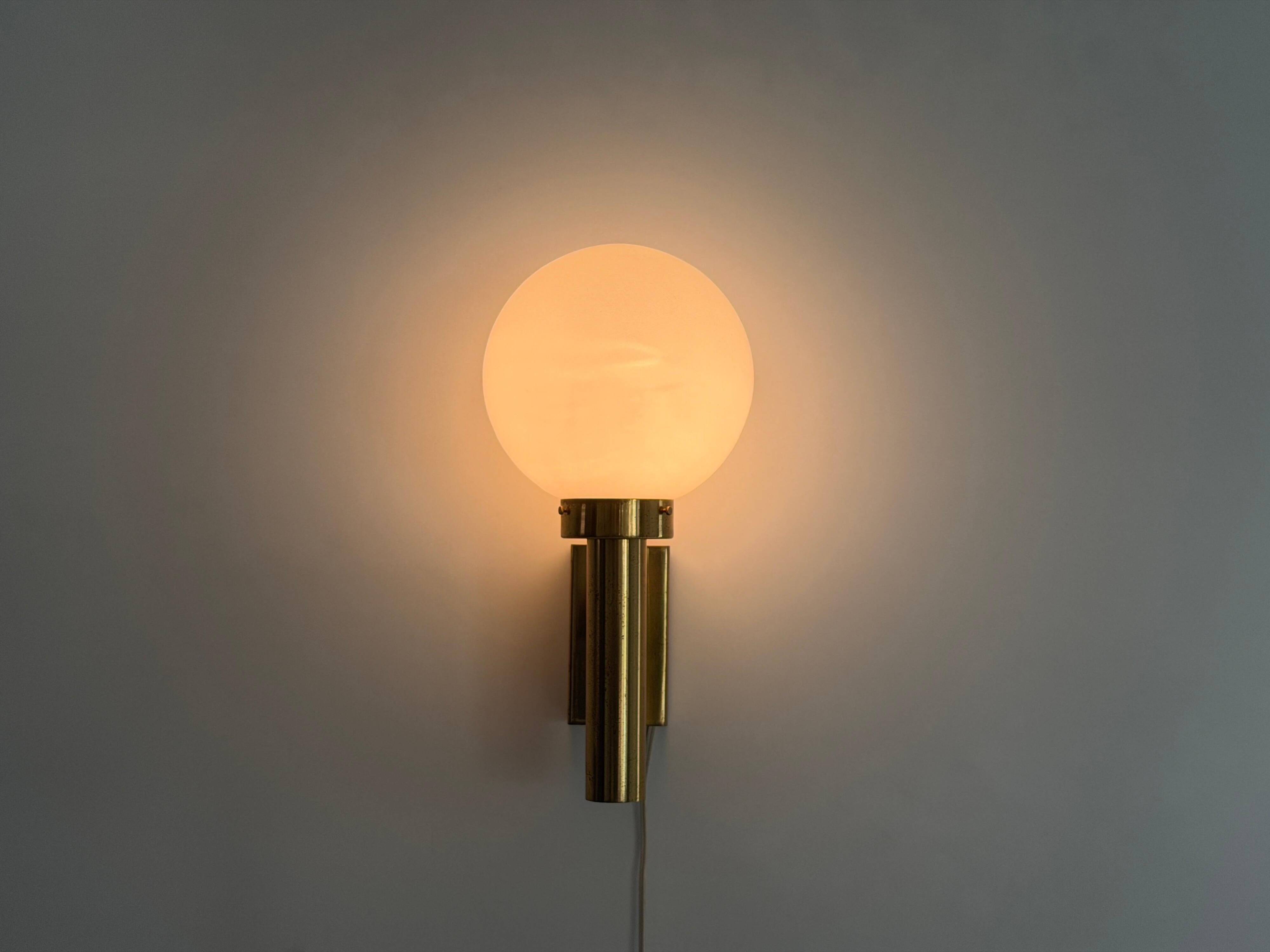Large minimalist cinema wall light in opal glass and heavy brass, 1960s, Germany