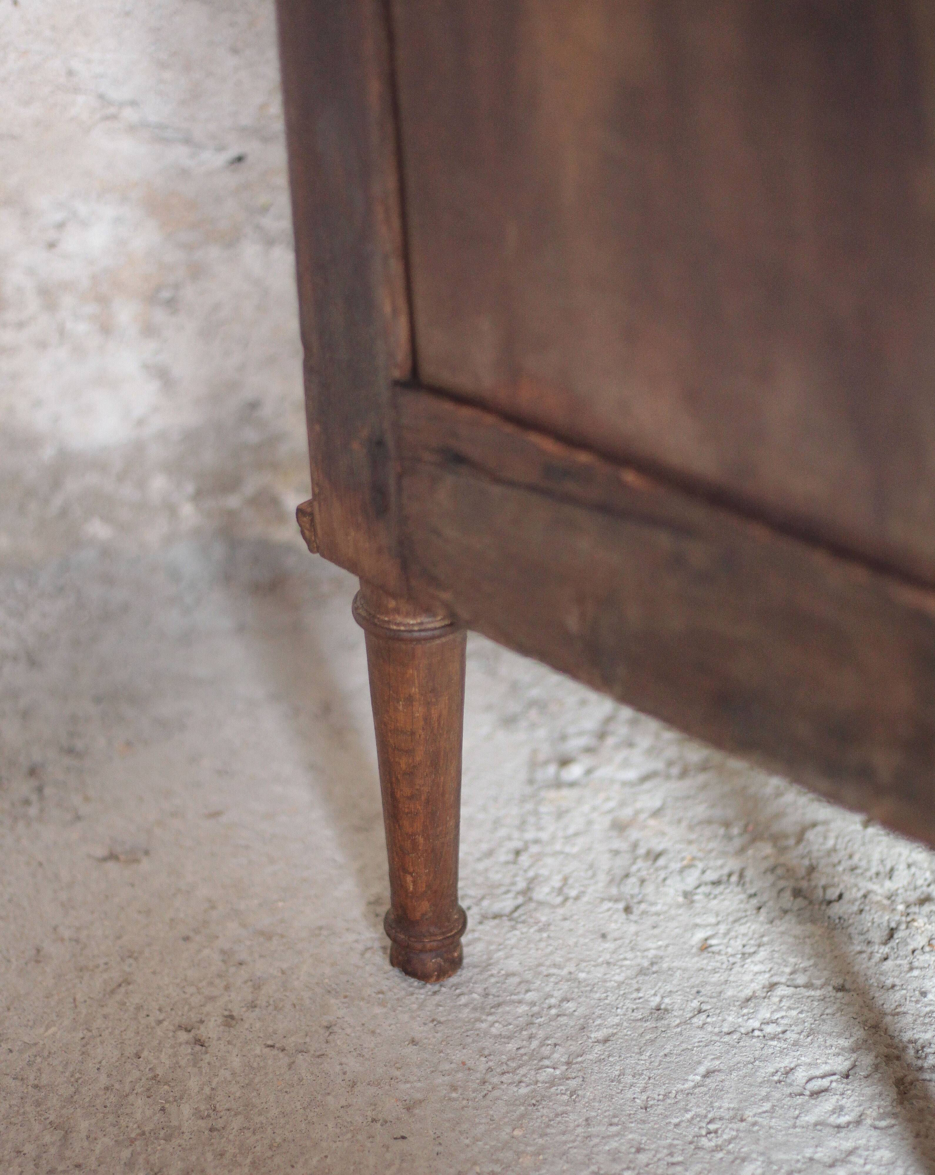 Antique wooden corner cabinet with a curved door.