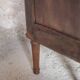 Antique wooden corner cabinet with a curved door.