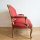 Two-seater Louis XV style sofa in red fabric.
