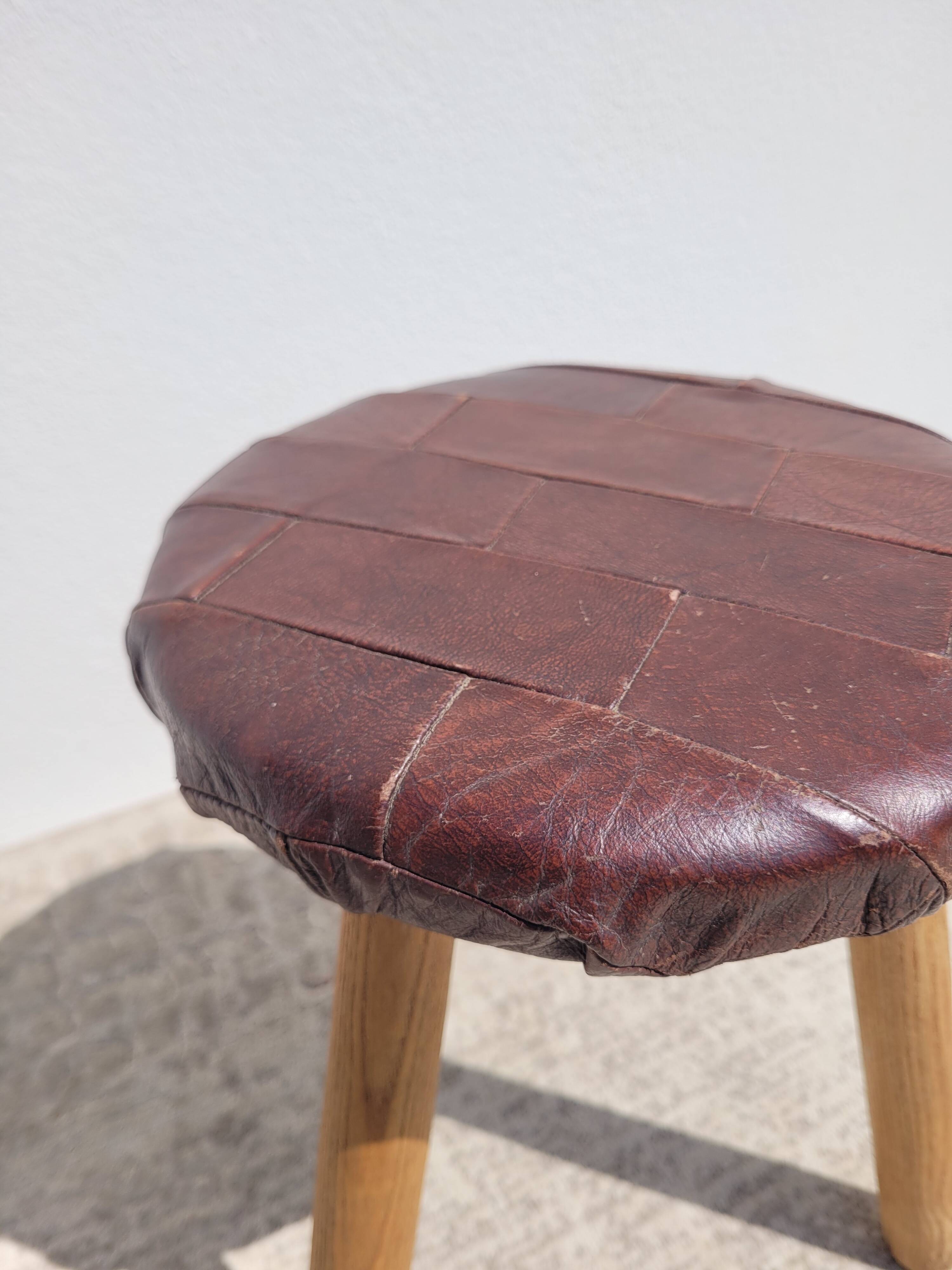Leather-upholstered tripod stool