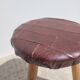 Leather-upholstered tripod stool