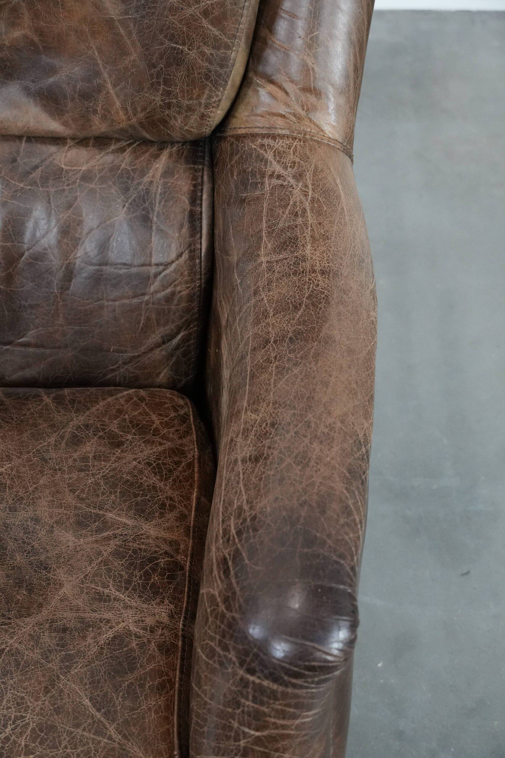 Very comfortable vintage cow leather armchair with beautiful colours