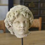 Sculpture of a head in reconstituted stone carved in the antique style of the 19th century