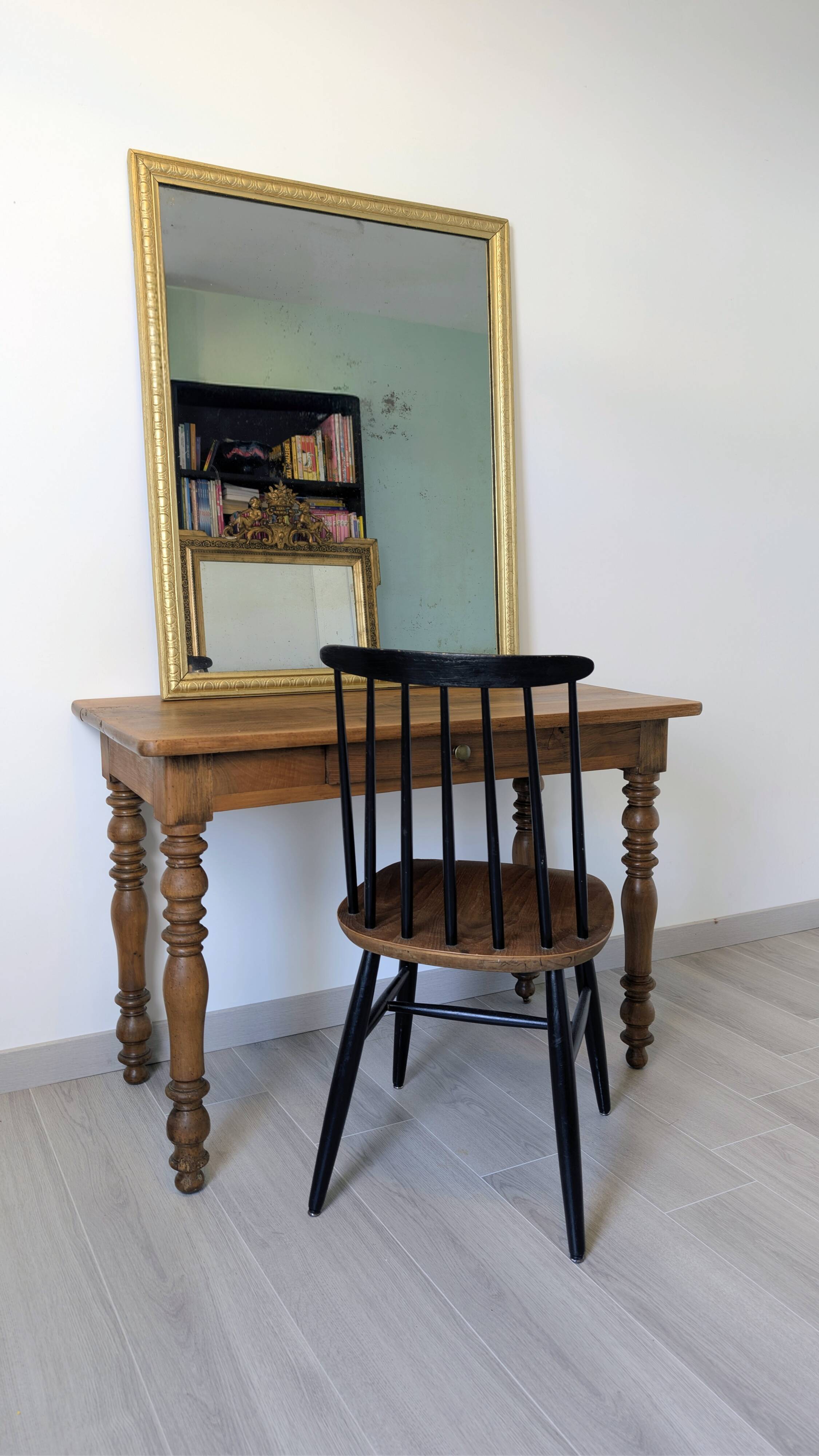 Antique writing table in the Napoleon III style with turned wooden legs.
