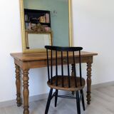 Antique writing table in the Napoleon III style with turned wooden legs.