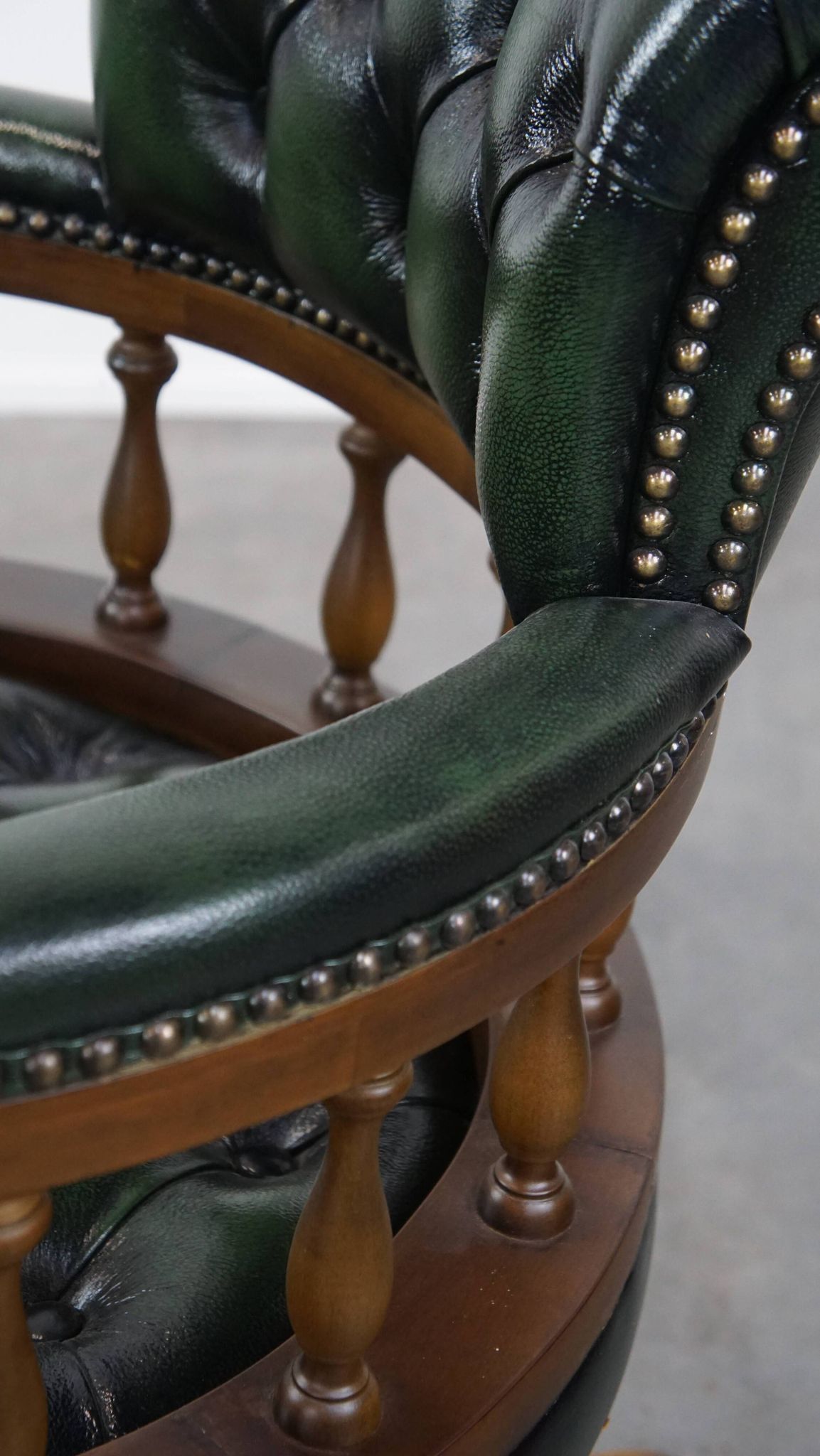 Dark green cowhide leather and wood chesterfield office chair on wheels