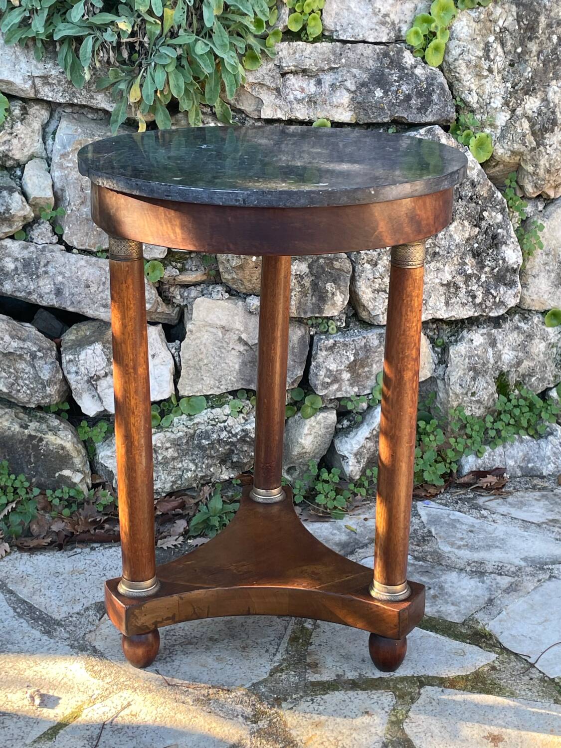 Empire style mahogany and mahogany veneer tripod pedestal table