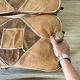 Pair of low Egyptian stools, camel saddles in wood, leather and brass