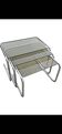 Nest tables in chrome metal and tinted glass.