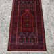 Vintage hand-knotted Persian Baluch prayer rug from the 1940s.