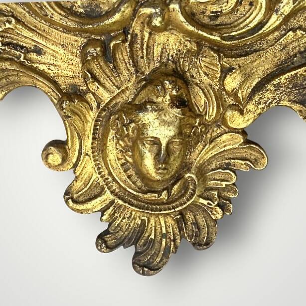 Antique bronze wall sconce with two candlesticks and beveled mirror