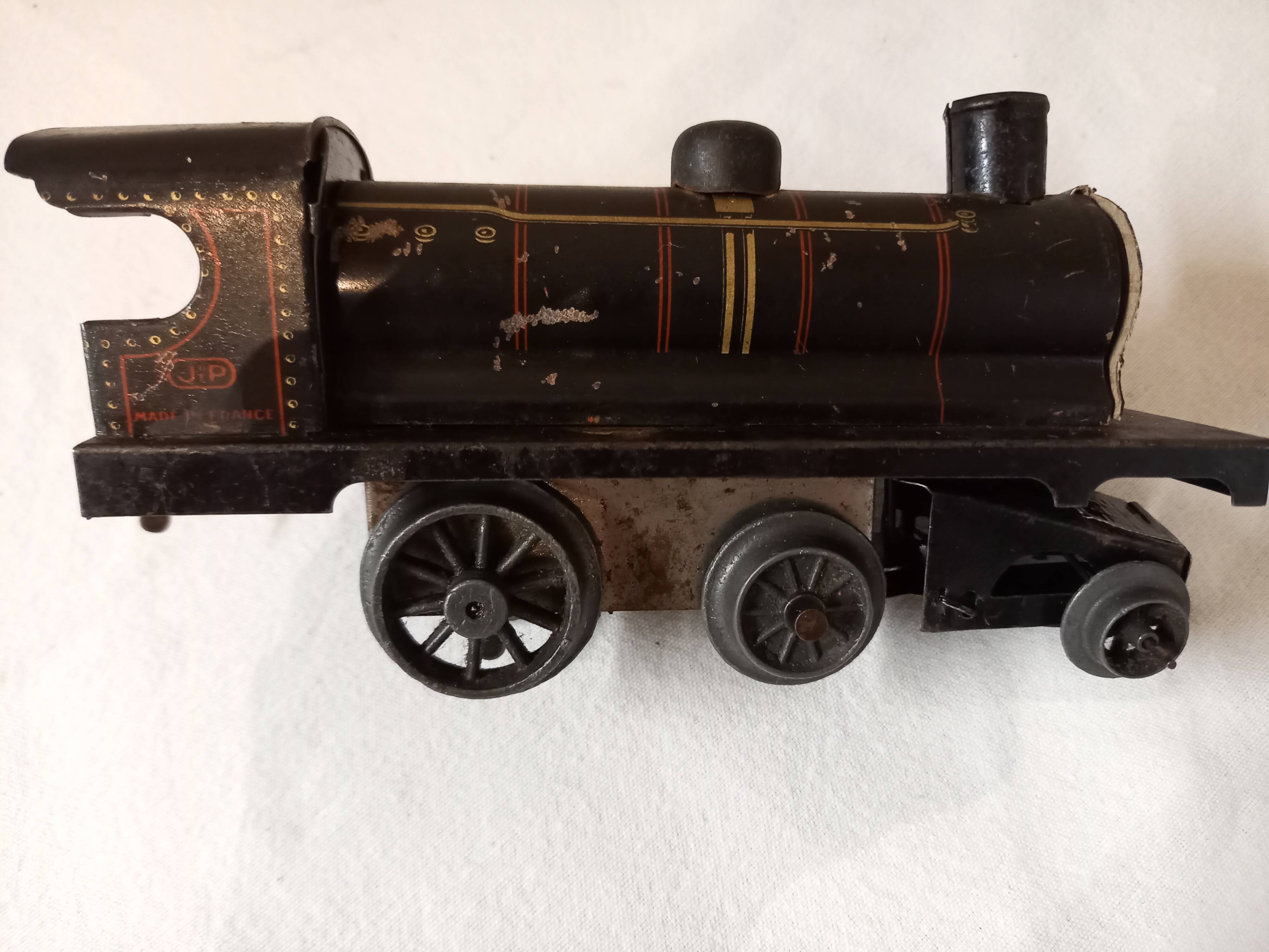 Small JEP mechanical train, including locomotive, tender, sleeping car, rail, 1930s