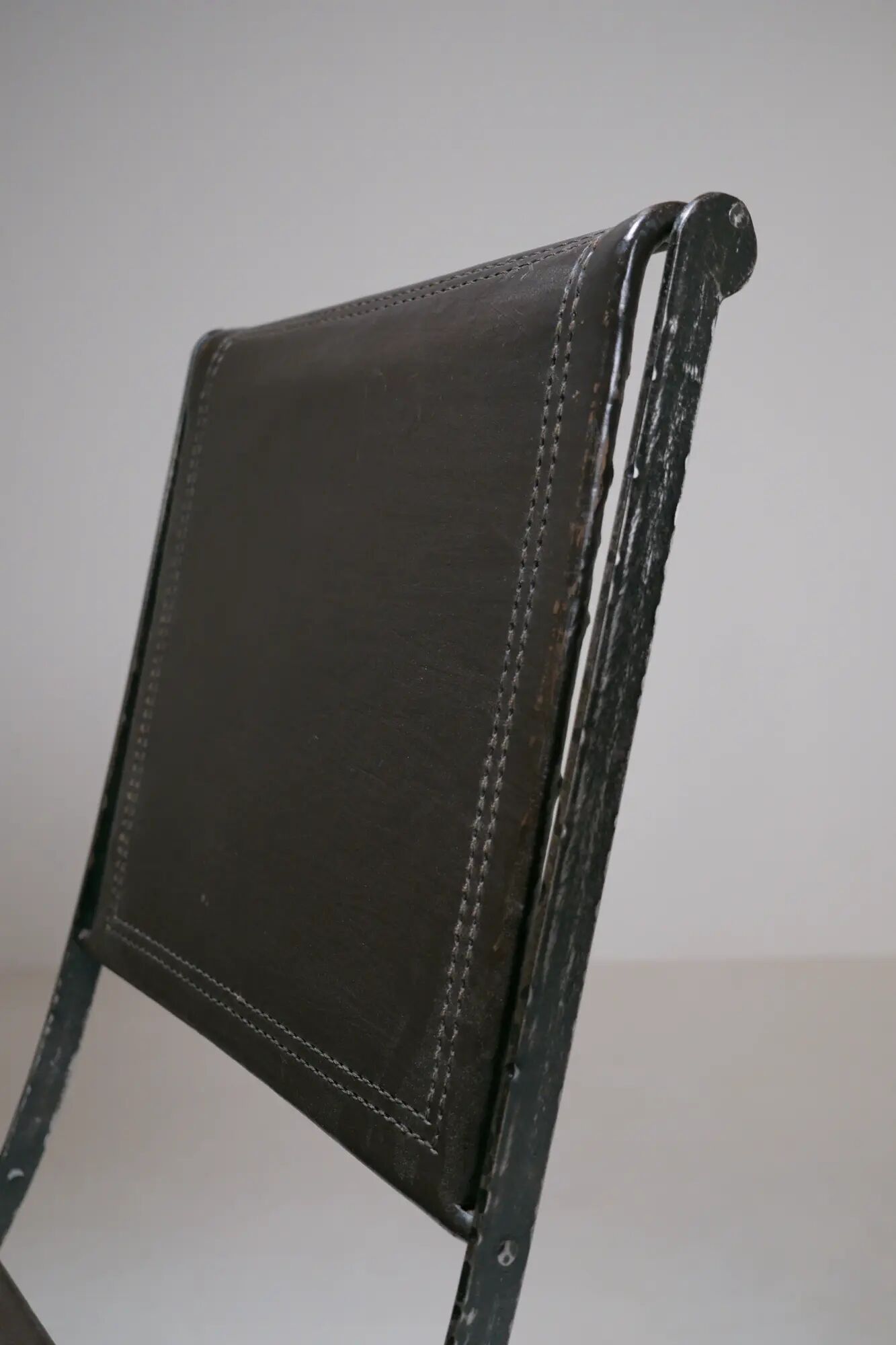 Foldable chair in wrought iron and leather. c. 1950