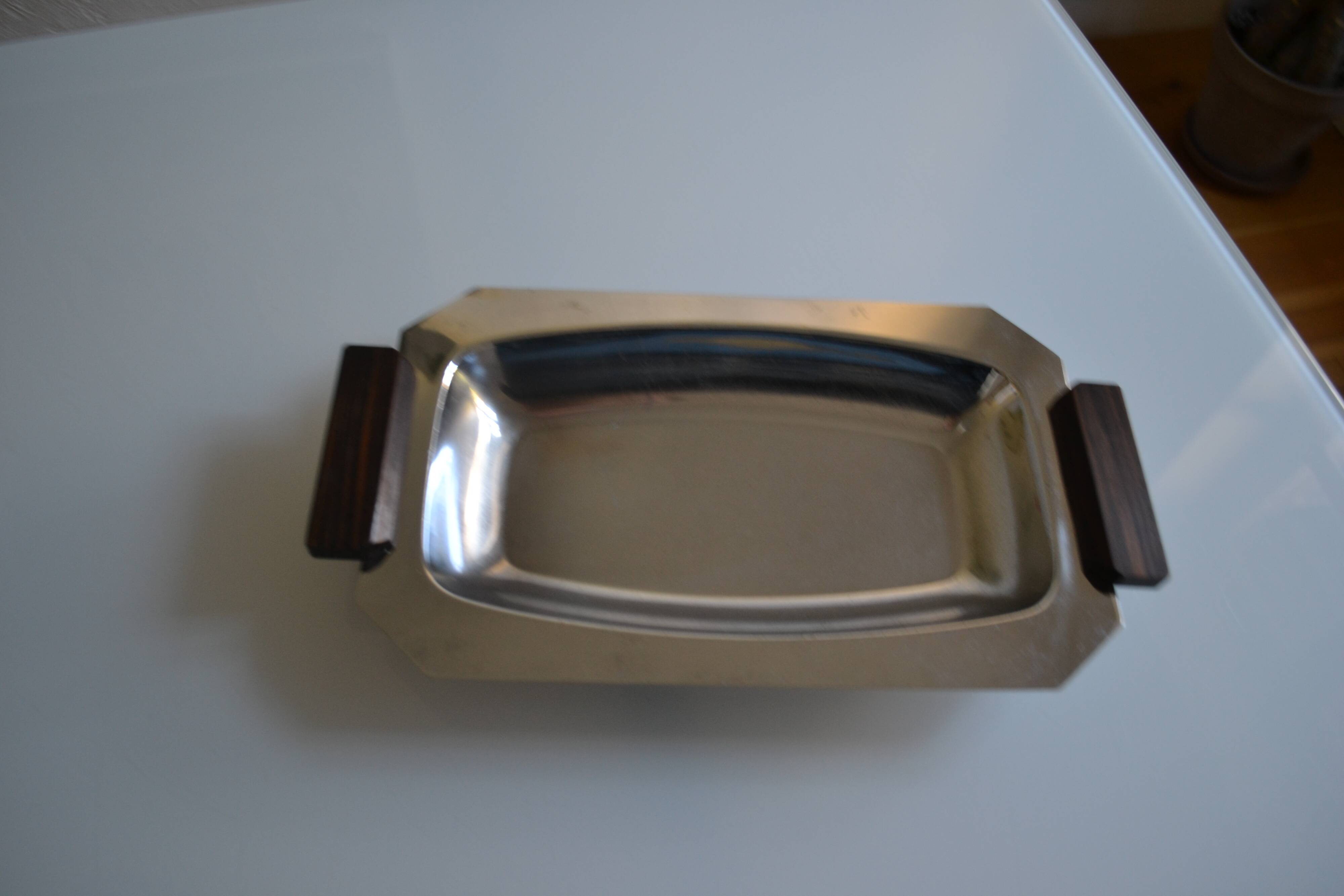 Art Deco serving dish in chrome metal with ebony handles.