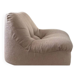 Vintage armchair reupholstered in boucle fabric.