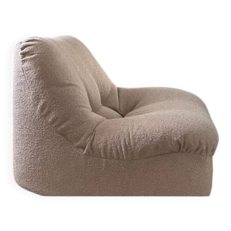 Vintage armchair reupholstered in boucle fabric.