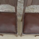 Two restyled leather-style chairs with nails