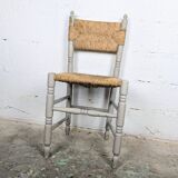 Rustic chair made of turned wood and straw.