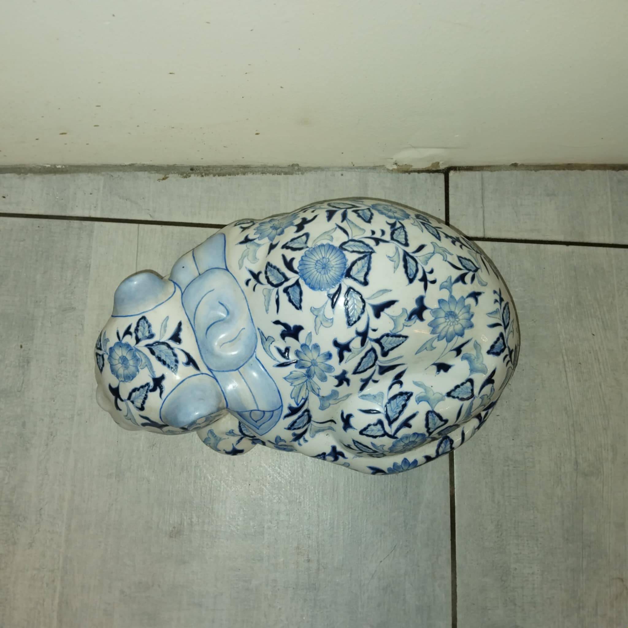 Vintage white and blue porcelain lying cat