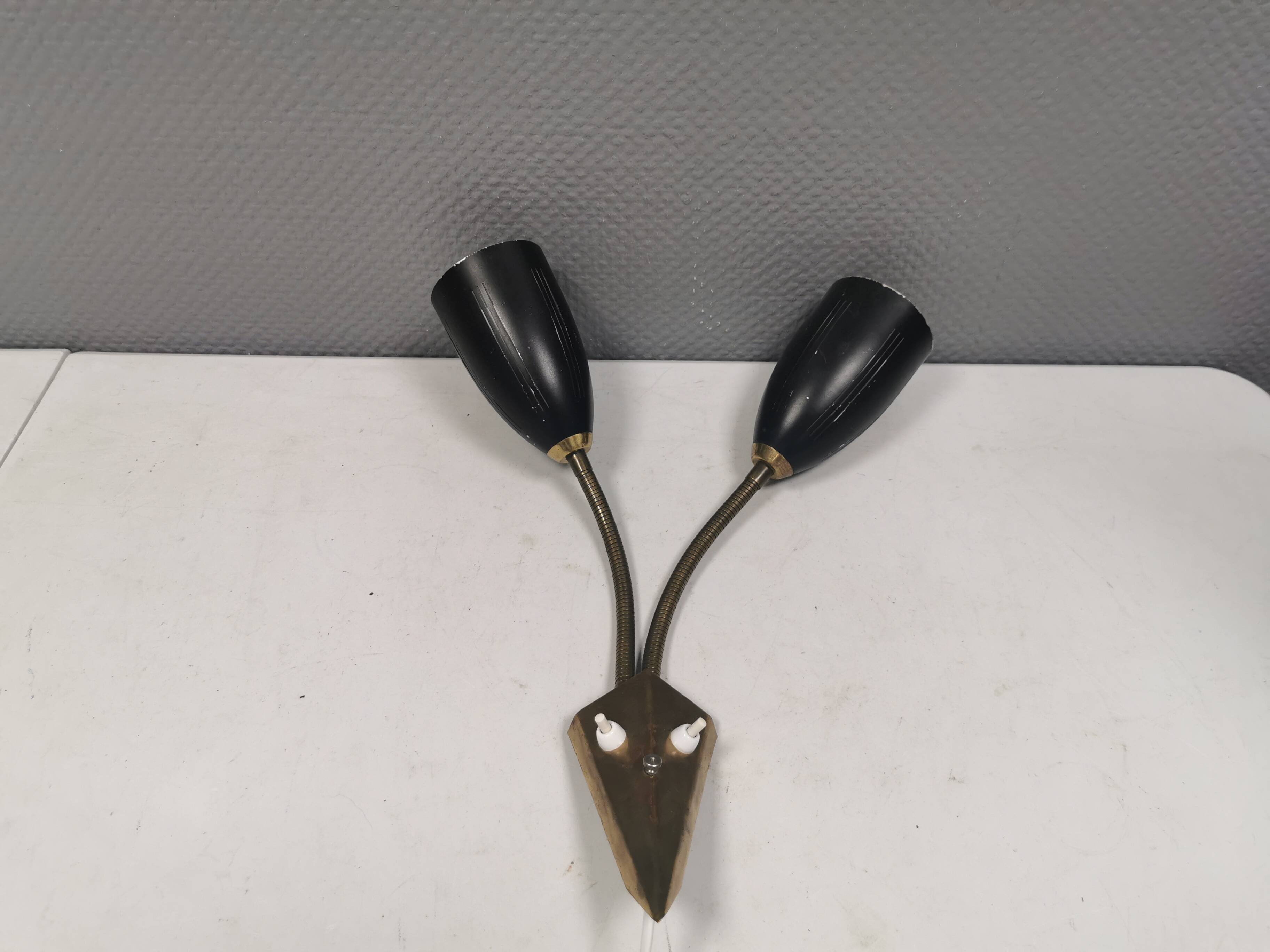 Older wall lamp with black metal shades and brass bend ‘arms’