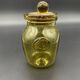 Yellow bubbled glass apothecary jar with cork lid.