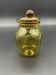 Yellow bubbled glass apothecary jar with cork lid.