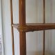 Storage column, wooden bookshelf and woven rattan.