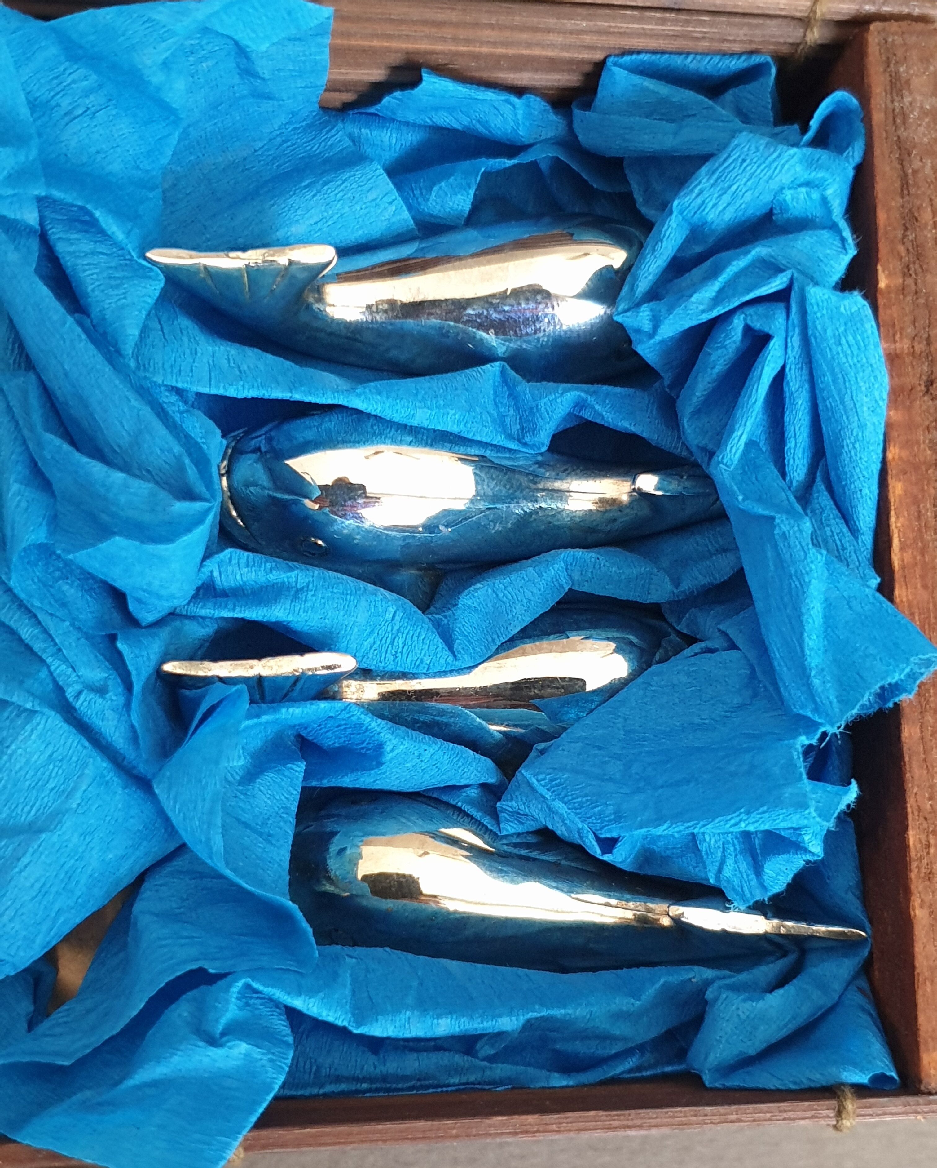 Lot 12 knife holders in the shape of a stylized whale or fish