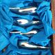 Lot 12 knife holders in the shape of a stylized whale or fish