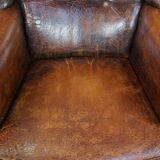 Cognac-colored vintage sheep leather wingback chair with character