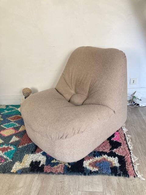 Vintage armchair reupholstered in boucle fabric.