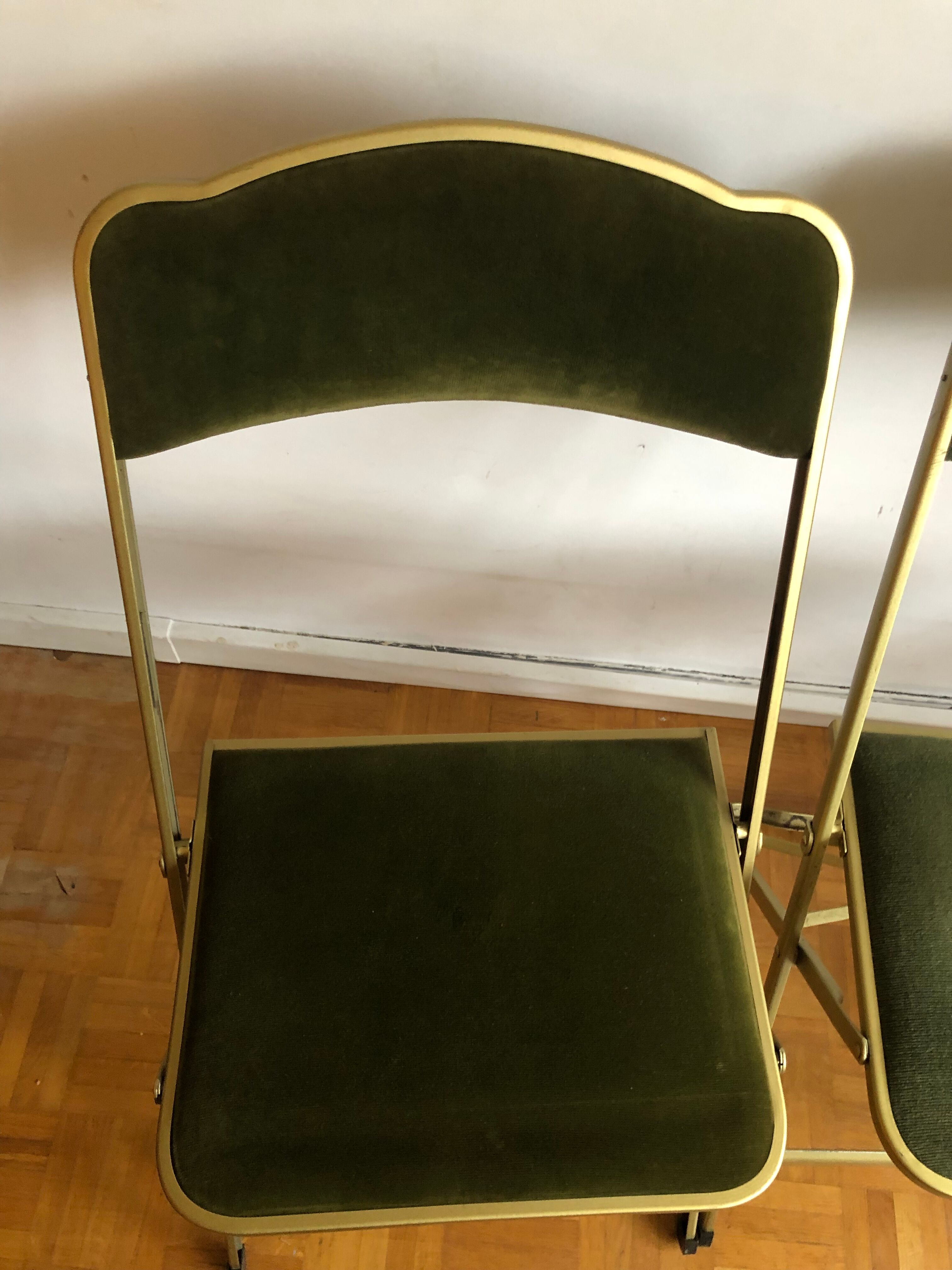 Set of three vintage green folding chairs