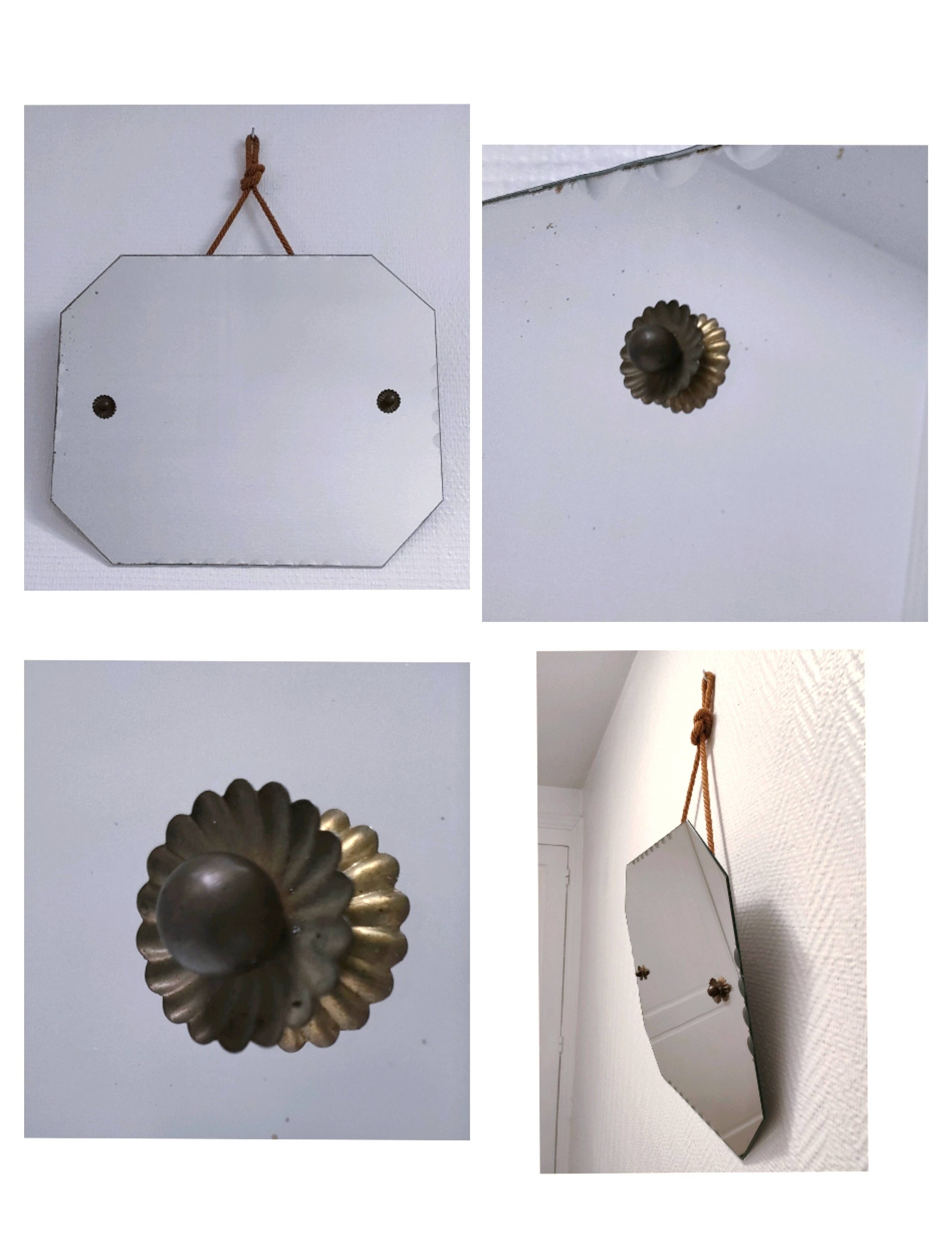 Octagonal mirror with brass hubcaps from the 60s