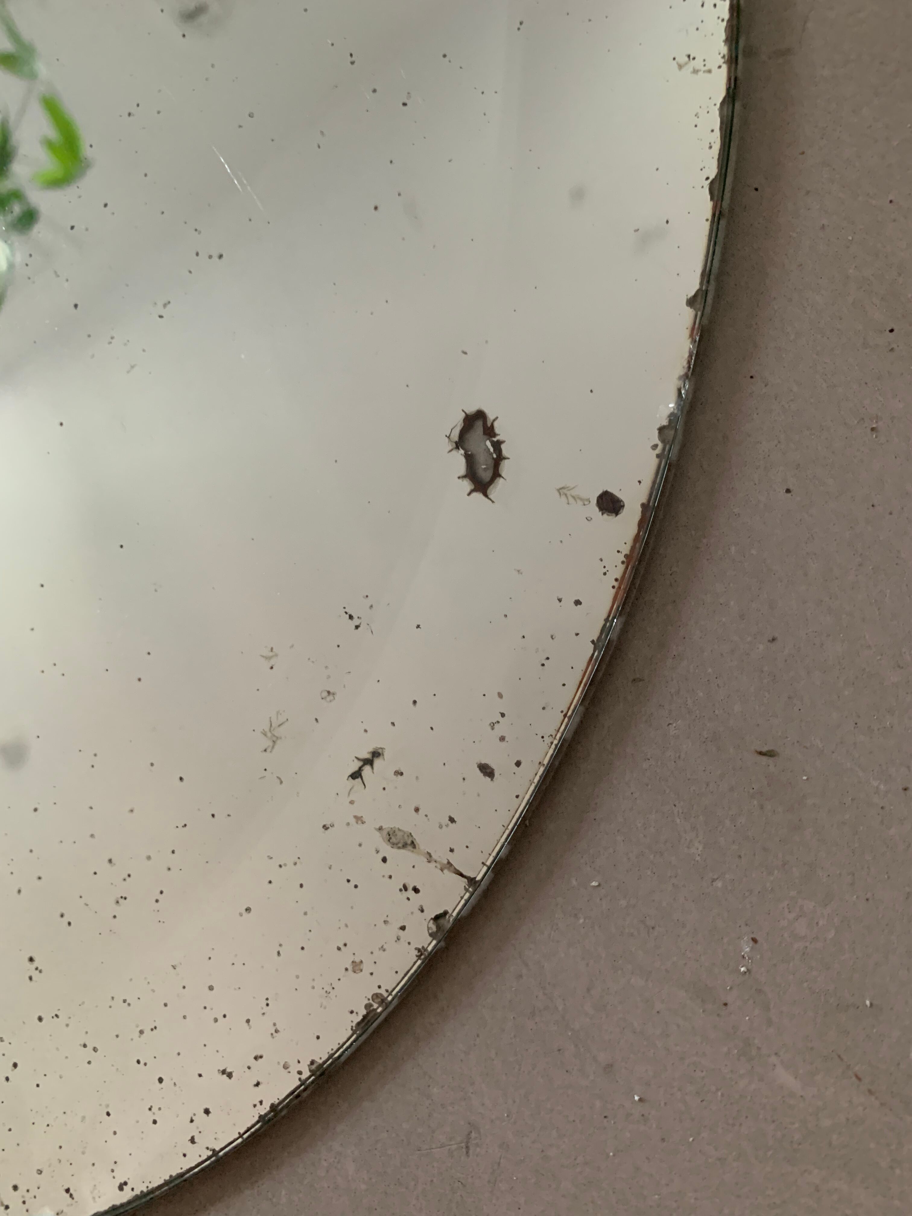 Old bevelled stitched oval mirror