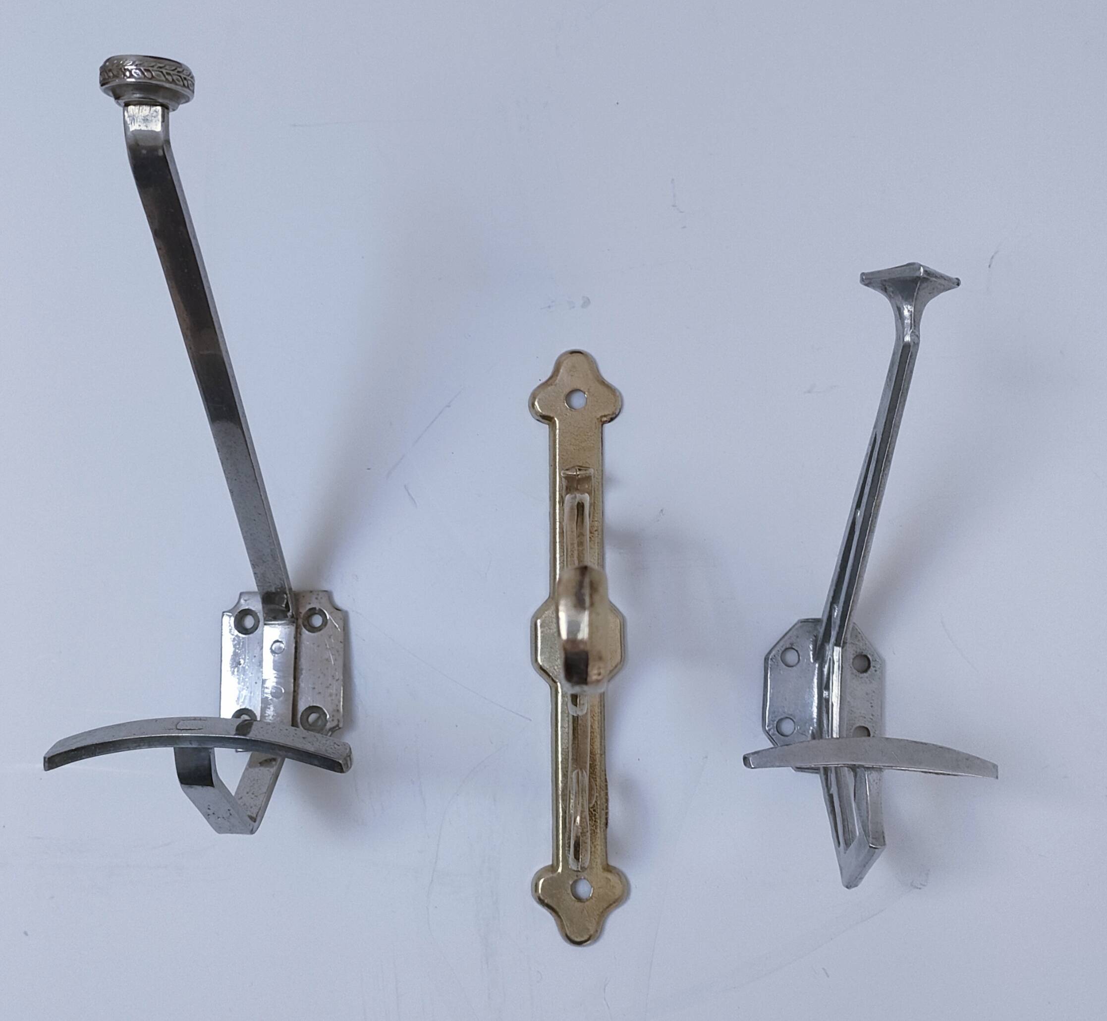Three brass, chrome, aluminum hooks, early 20th century