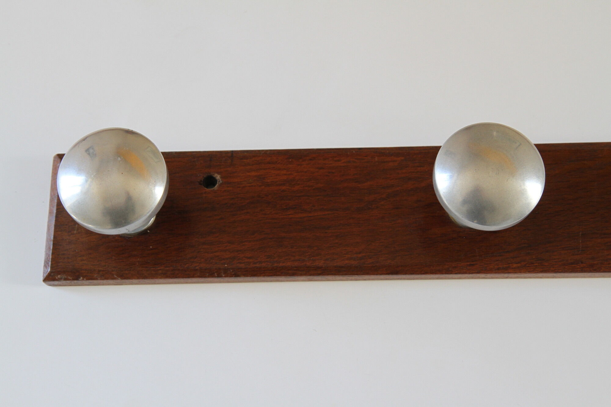 Wooden and stainless steel coat holders from the 1920s