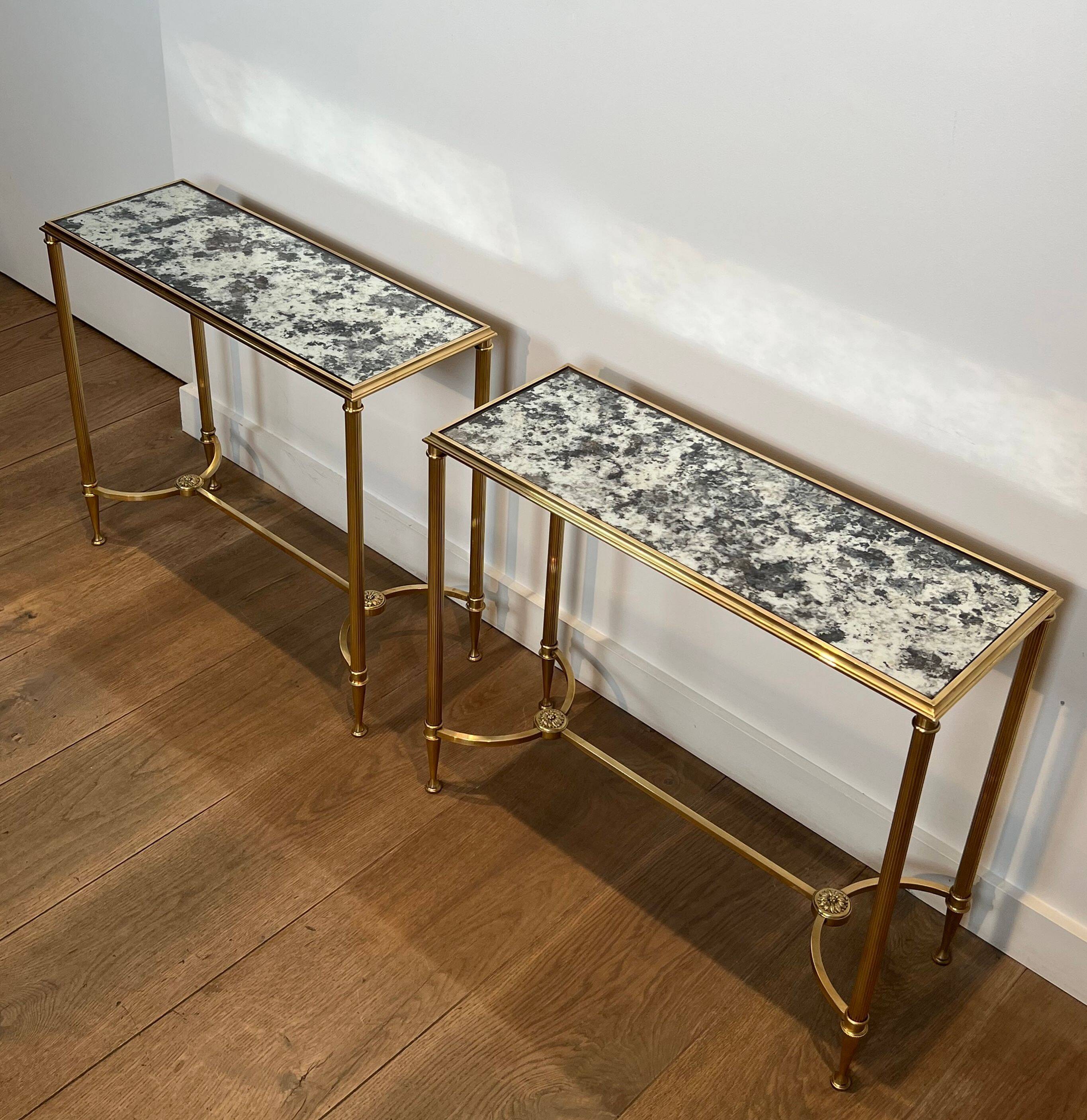 Pair of brass and antique mirror side tables from the Baguès house.