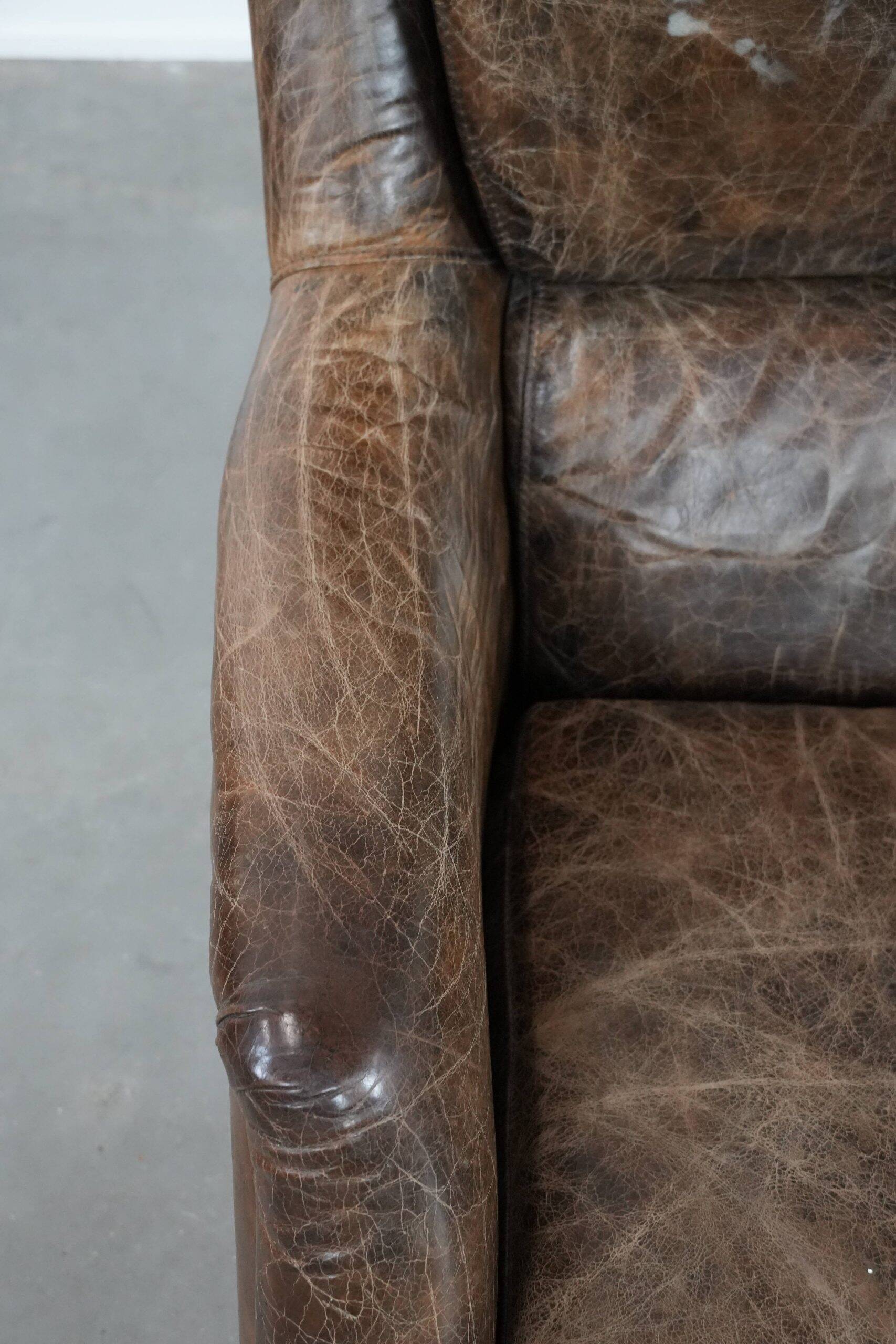 Very comfortable vintage cow leather armchair with character