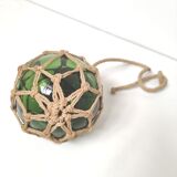 Green ball marine float in glass and rope