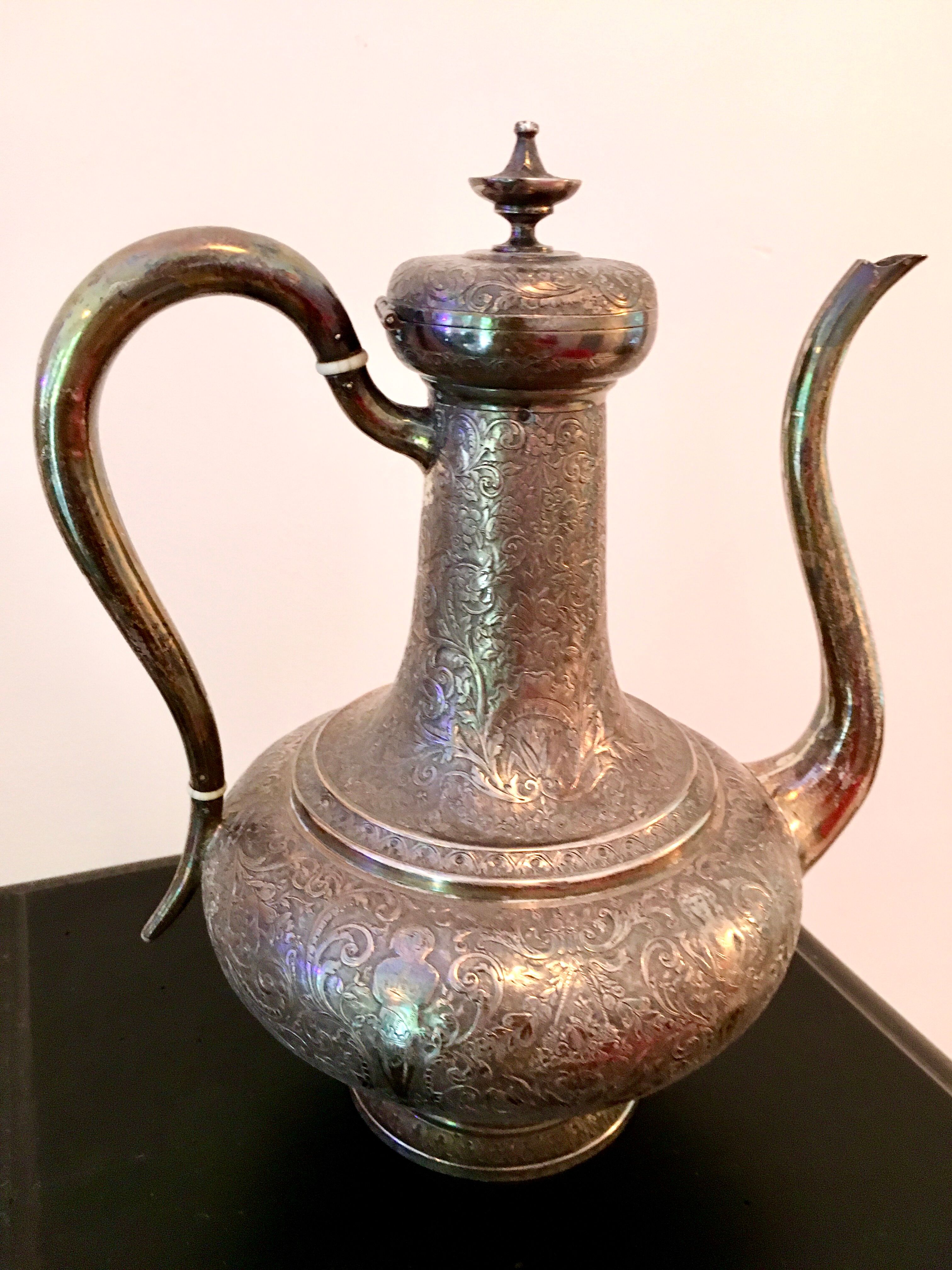Oriental teapot made of crafted silver metal