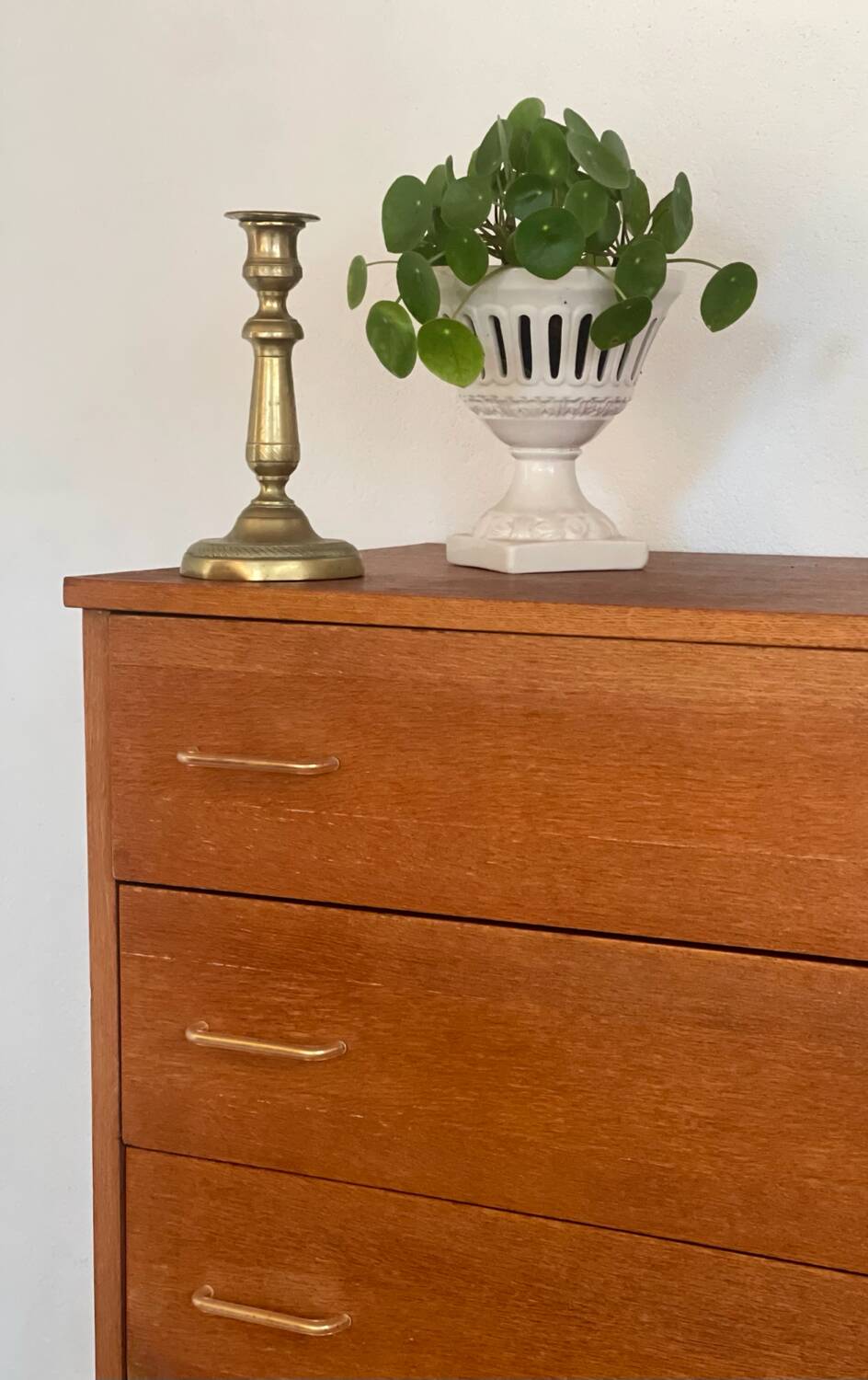 Vintage 1960s chest of drawers with covered handles.