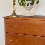 Vintage 1960s chest of drawers with covered handles.