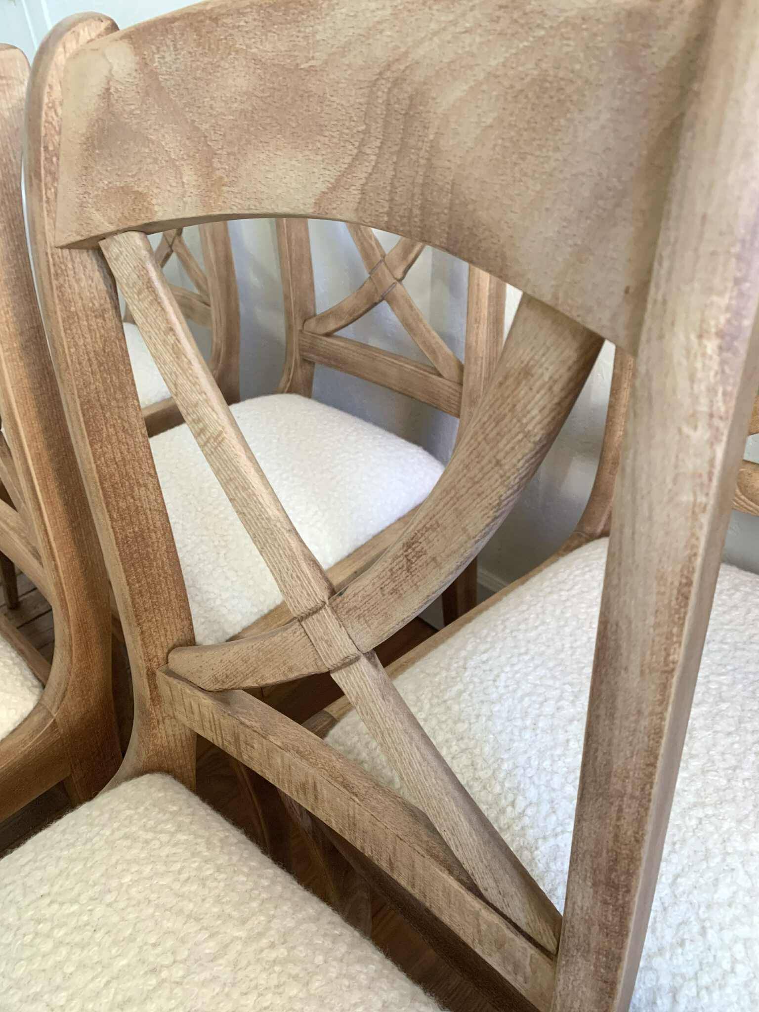 Set of 6 cross-back chairs in solid wood, with white boucle seats.