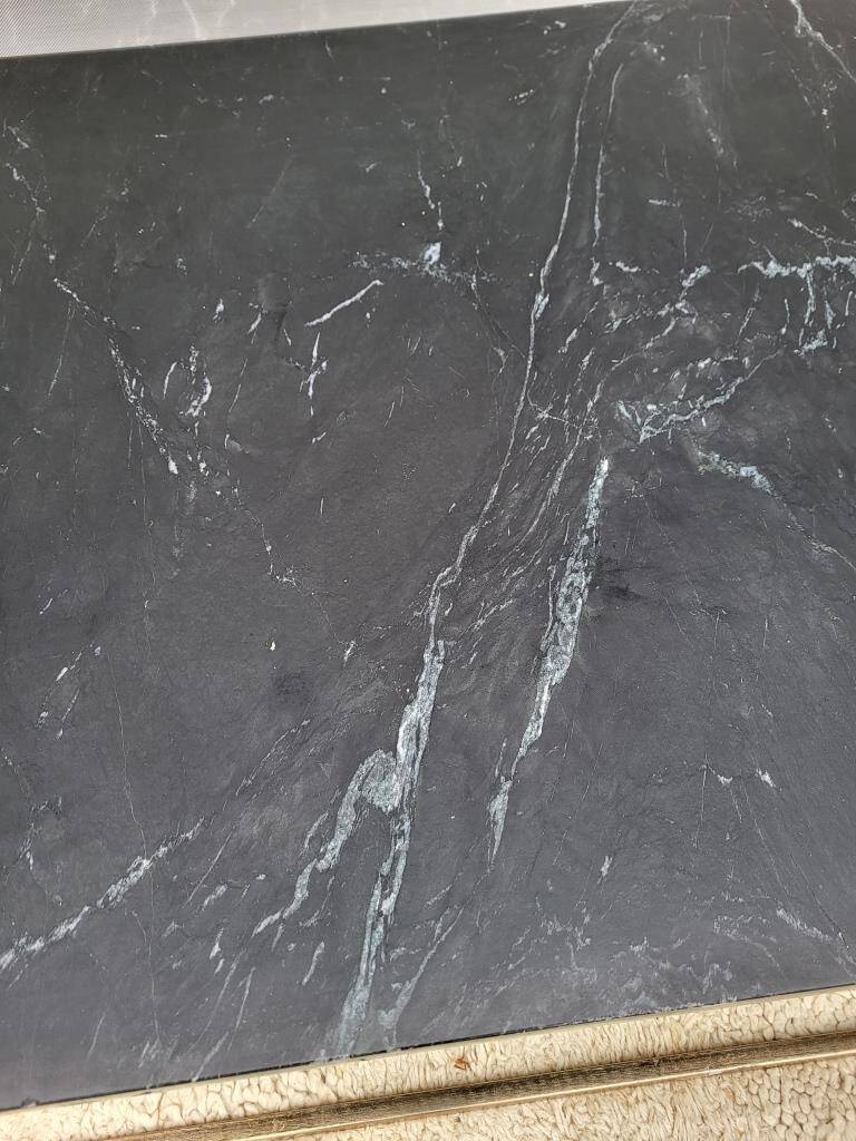 Coffee table or black marble and brass display "in its own juice"