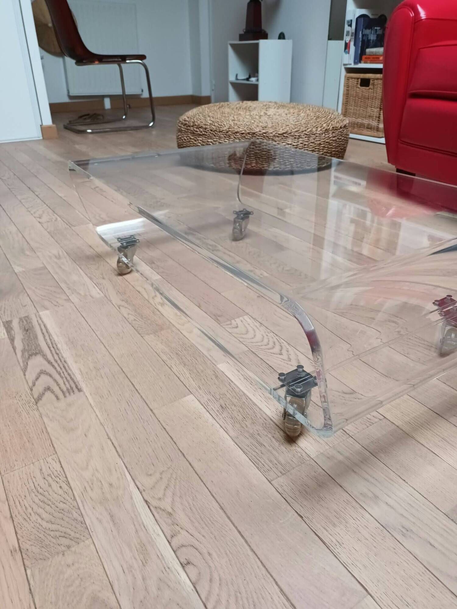 Design coffee table from Habitat in transparent plexiglass, mounted on wheels.