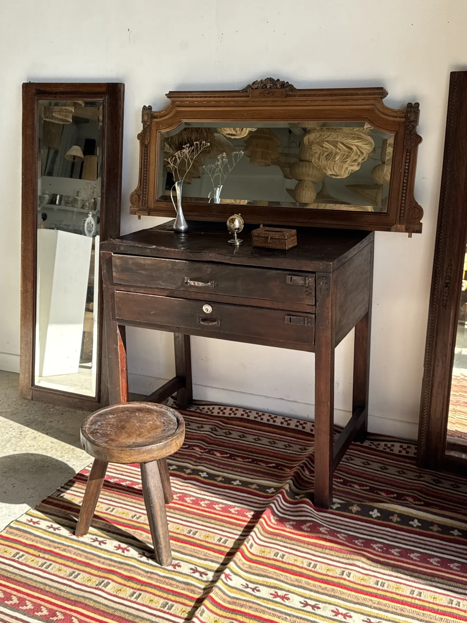 Antique mirror door (left) of a brown oak wardrobe with bevelled glass.