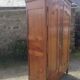Louis XV Nantaise wardrobe carved with grape clusters, gendarme hat in fine cherry wood, late 19th century.